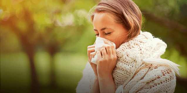 Person Sneezing into Tissue